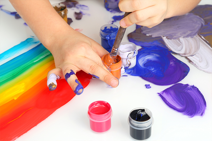 Barnhänder som målar.